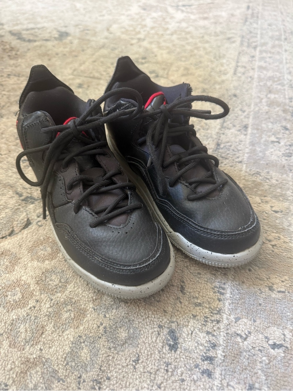 Jordan Kids Black Sneakers with Gray Speckled Sole and Red Accents